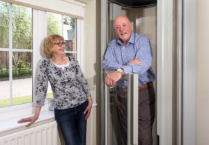 A husband and wife enjoying their Lifton Home Lift.