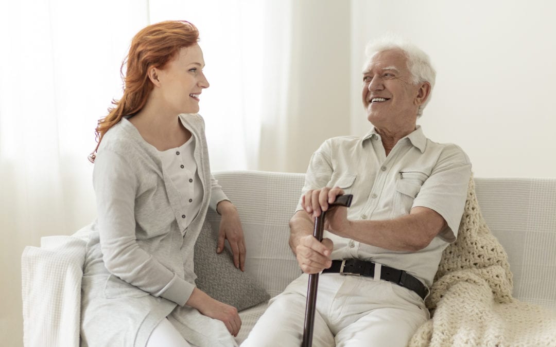 Smiling senior man having fun with happy daughter at home