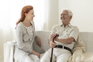 Smiling senior man having fun with happy daughter at home